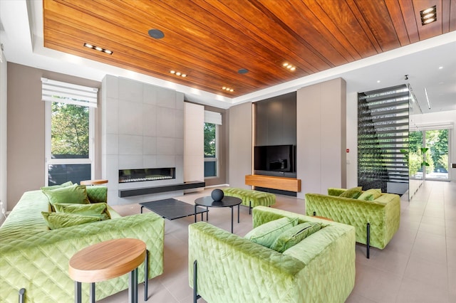 1555 Stevenson Rd, Hewlett, NY 11557 - living area featuring a raised ceiling, wood ceiling, light tile patterned floors, a tiled fireplace, and recessed lighting