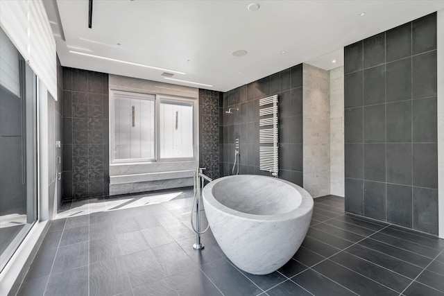1555 Stevenson Rd, Hewlett, NY 11557 - bathroom with tile walls, a towel warming rack, a walk in shower, radiator, and a freestanding bath