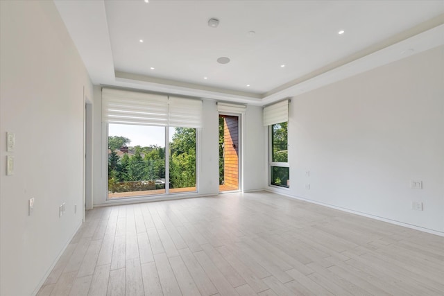 1555 Stevenson Rd, Hewlett, NY 11557 - unfurnished room featuring a tray ceiling, light wood finished floors, and a smoke detector