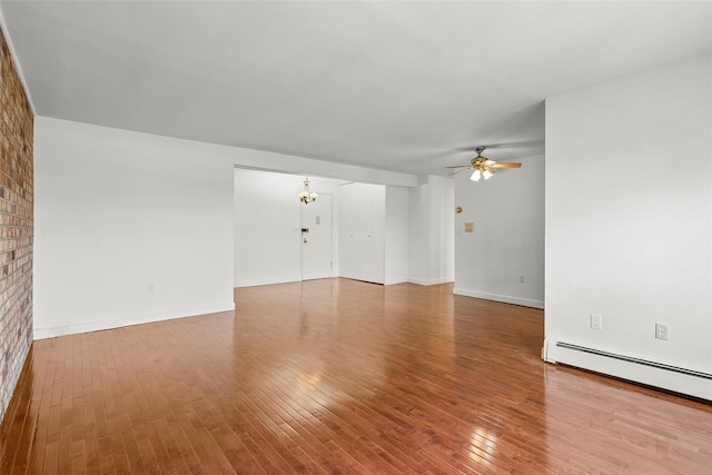 505 Central Ave Unit 609, White Plains, NY 10606 - unfurnished living room with a ceiling fan, baseboard heating, wood finished floors, and a chandelier