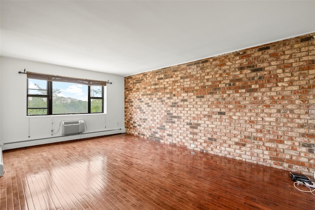 505 Central Ave Unit 609, White Plains, NY 10606 - empty room featuring a baseboard radiator, wood finished floors, an AC wall unit, and brick wall