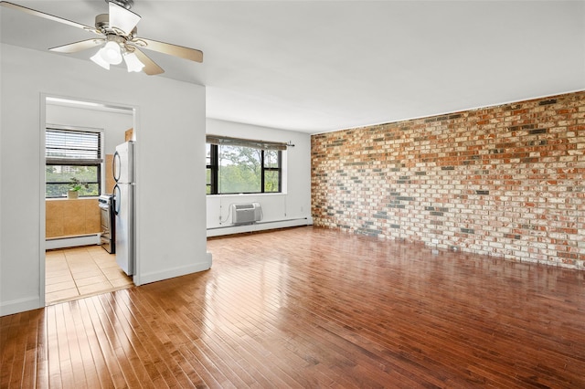 505 Central Ave Unit 609, White Plains, NY 10606 - unfurnished living room with a baseboard heating unit, light wood finished floors, brick wall, ceiling fan, and a wall unit AC
