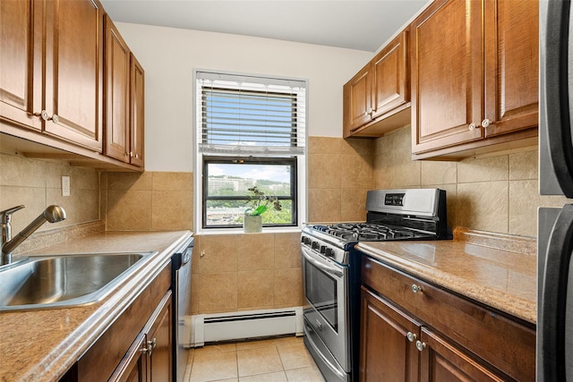 505 Central Ave Unit 609, White Plains, NY 10606 - kitchen with stainless steel appliances, baseboard heating, light countertops, light tile patterned flooring, and decorative backsplash