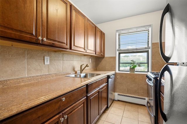 505 Central Ave Unit 609, White Plains, NY 10606 - kitchen featuring stainless steel appliances, a baseboard radiator, light tile patterned flooring, and light countertops