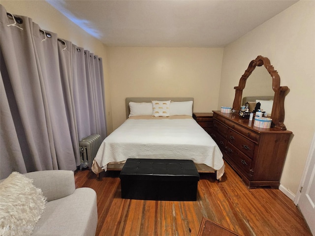 7622 60th Ln, Glendale, NY 11385 - bedroom with radiator and wood finished floors