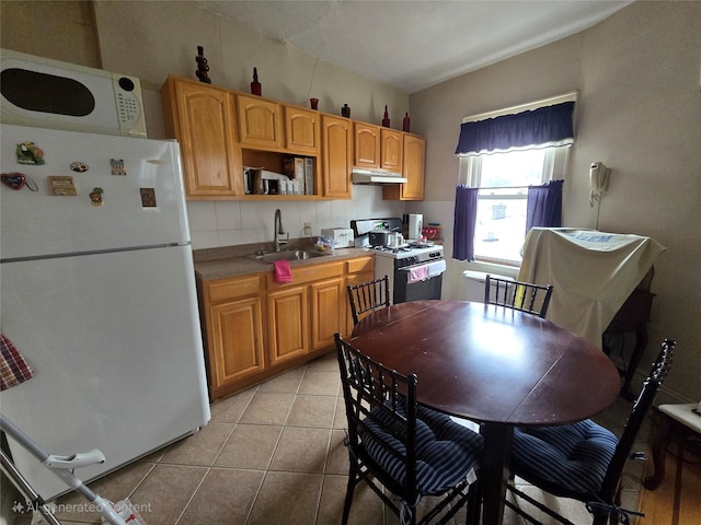 7622 60th Ln, Glendale, NY 11385 - kitchen featuring white appliances, under cabinet range hood, and light tile patterned floors