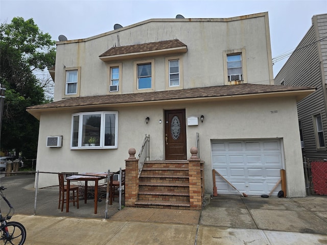 7622 60th Ln, Glendale, NY 11385 - multi unit property featuring stucco siding, a shingled roof, a wall mounted air conditioner, and concrete driveway