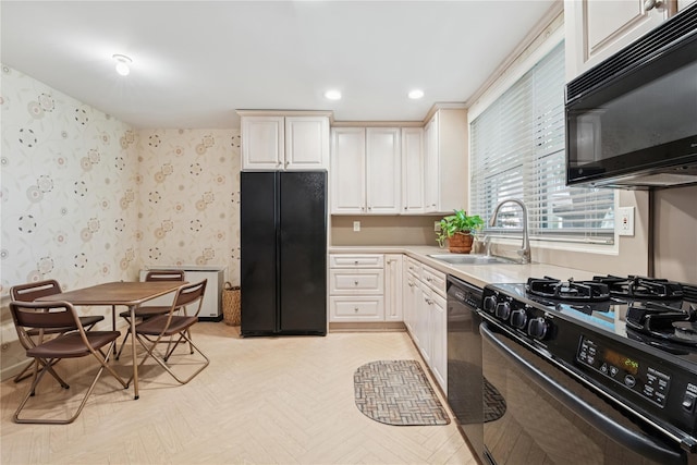 1390 Broadway Unit 118, Hewlett, NY 11557 - kitchen with black appliances, recessed lighting, wallpapered walls, light countertops, and white cabinetry