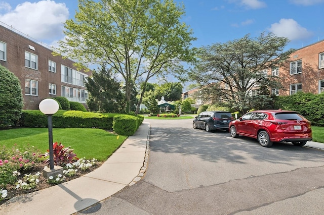 1390 Broadway Unit 118, Hewlett, NY 11557 - view of asphalt road featuring sidewalks, curbs, and a residential view