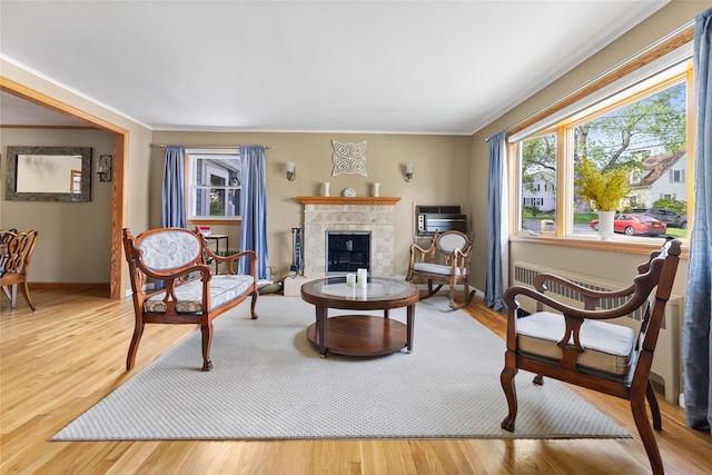 37 Rutland St, Mount Kisco, NY 10549 - living area with crown molding, wood finished floors, a wall mounted AC, and a tiled fireplace