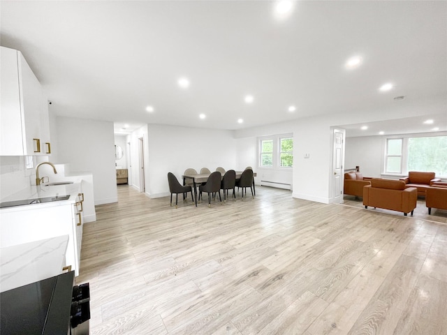 811 Happy Ave, Swan Lake, NY 12783 - living area featuring a baseboard heating unit, light wood-style flooring, recessed lighting, and baseboards