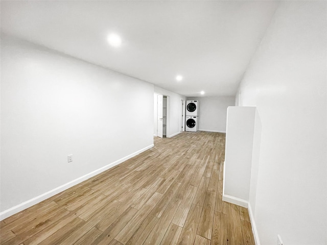 811 Happy Ave, Swan Lake, NY 12783 - unfurnished living room with stacked washing machine and dryer, light wood-style floors, recessed lighting, and baseboards