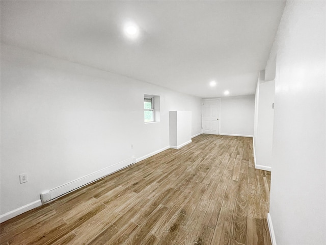 811 Happy Ave, Swan Lake, NY 12783 - unfurnished room featuring wood finished floors, baseboards, recessed lighting, and a baseboard radiator