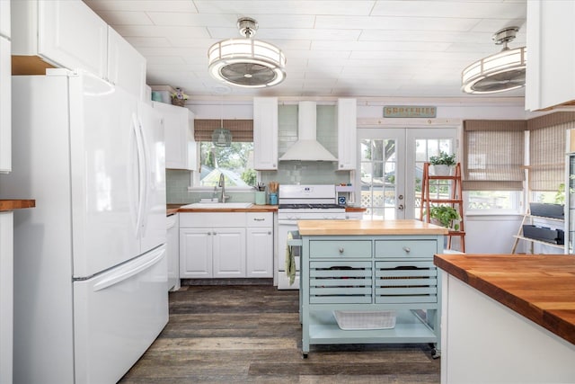100 Virginia St, Valley Stream, NY 11580 - kitchen with wood counters, white appliances, wall chimney exhaust hood, and white cabinetry