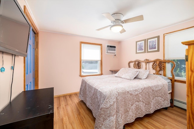 100 Virginia St, Valley Stream, NY 11580 - bedroom with a baseboard heating unit, wood finished floors, a wall mounted AC, and a ceiling fan