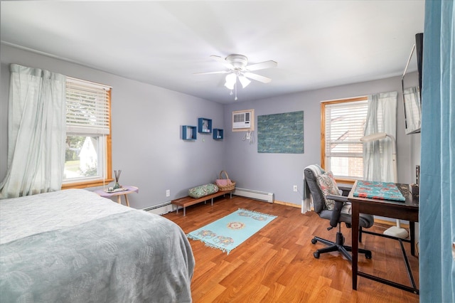100 Virginia St, Valley Stream, NY 11580 - bedroom featuring a baseboard heating unit, light wood-style floors, an office area, a wall mounted AC, and ceiling fan