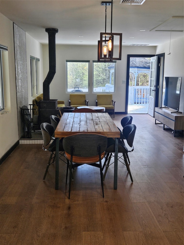 470 Shaver Hill Rd, Andes, NY 13731 - dining area with dark wood-type flooring, baseboards, and a wood stove