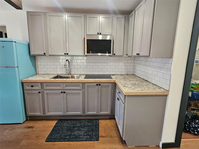 470 Shaver Hill Rd, Andes, NY 13731 - kitchen featuring stainless steel microwave, freestanding refrigerator, a sink, gray cabinets, and black electric stovetop