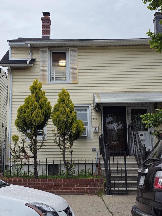 1756 Zerega Ave, Bronx, NY 10462 - view of front facade with a chimney and a fenced front yard