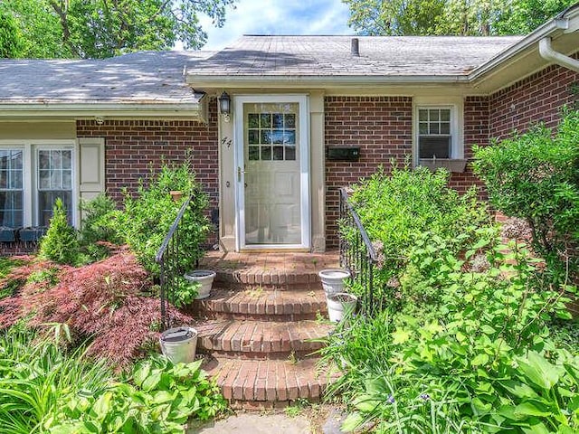 44 Glenwood Rd, Glen Head, NY 11545 - doorway to property with brick siding and roof with shingles
