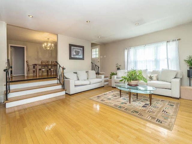 44 Glenwood Rd, Glen Head, NY 11545 - living room with stairway, wood finished floors, and a chandelier