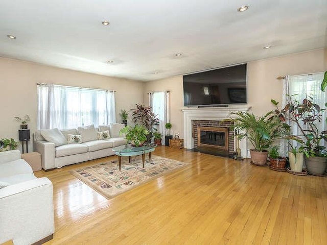 44 Glenwood Rd, Glen Head, NY 11545 - living room featuring wood finished floors, a brick fireplace, and recessed lighting
