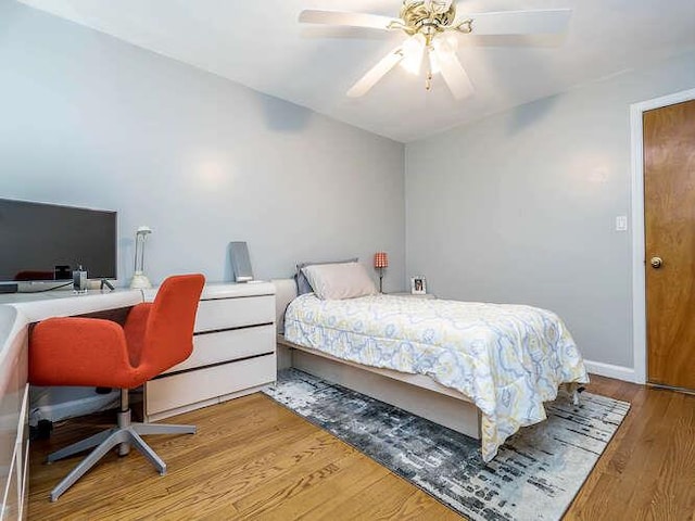 44 Glenwood Rd, Glen Head, NY 11545 - bedroom with an office area, wood finished floors, and a ceiling fan
