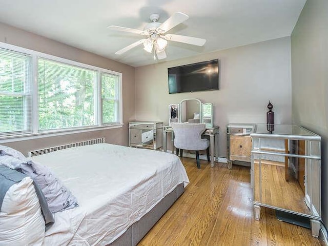 44 Glenwood Rd, Glen Head, NY 11545 - bedroom featuring wood finished floors, radiator heating unit, and ceiling fan