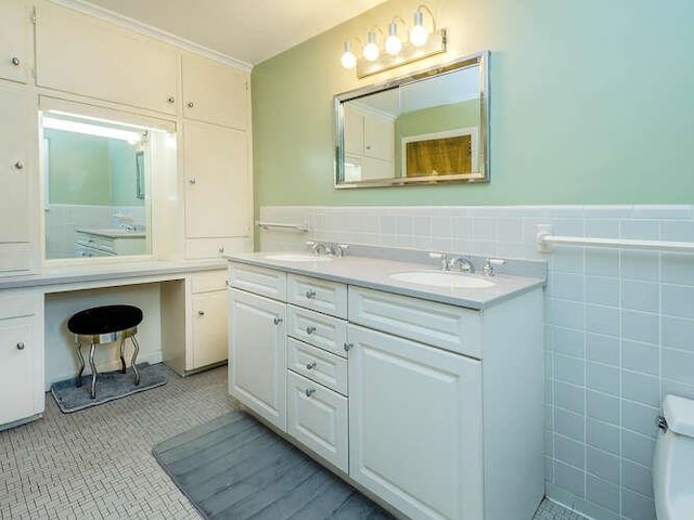 44 Glenwood Rd, Glen Head, NY 11545 - bathroom with tile walls, double vanity, a wainscoted wall, toilet, and tile patterned flooring
