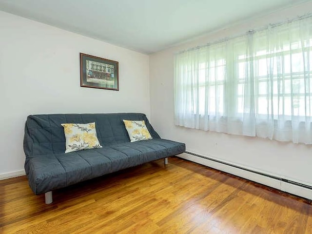 44 Glenwood Rd, Glen Head, NY 11545 - sitting room featuring a baseboard radiator, plenty of natural light, and wood finished floors