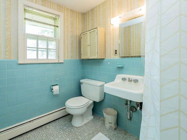 44 Glenwood Rd, Glen Head, NY 11545 - bathroom featuring a baseboard radiator, wallpapered walls, tile walls, toilet, and a sink