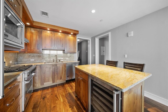 5 Renaissance Sq Unit 23B, White Plains, NY 10601 - kitchen featuring beverage cooler, appliances with stainless steel finishes, dark wood-style flooring, decorative backsplash, and a sink