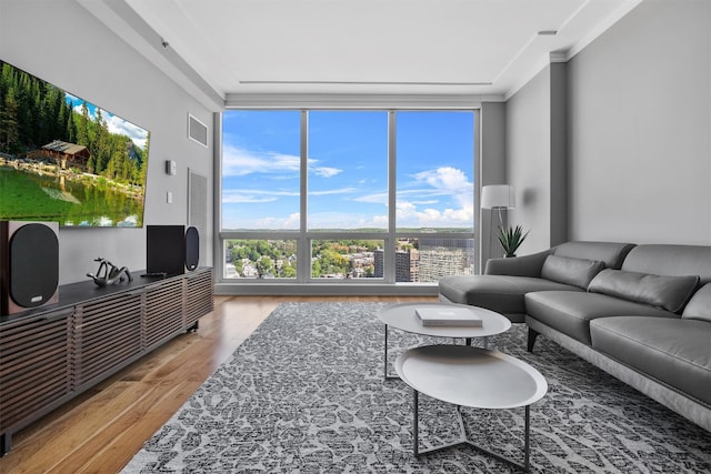 5 Renaissance Sq Unit 23B, White Plains, NY 10601 - living room featuring light wood-style flooring, healthy amount of natural light, floor to ceiling windows, and ornamental molding