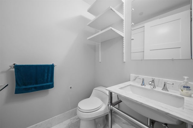 5 Renaissance Sq Unit 23B, White Plains, NY 10601 - bathroom with marble finish flooring, baseboards, toilet, and a sink