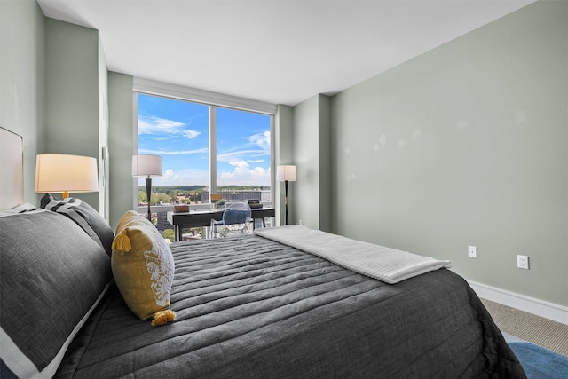 5 Renaissance Sq Unit 23B, White Plains, NY 10601 - bedroom featuring expansive windows, carpet floors, and baseboards