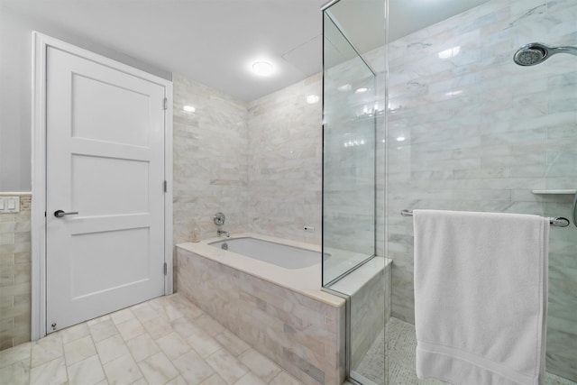 5 Renaissance Sq Unit 23B, White Plains, NY 10601 - full bathroom with a shower stall, a bath, and tile walls
