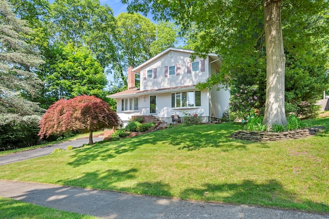 29 Ravenwood Dr, Kings Park, NY 11754 - view of front of house featuring a front lawn and a chimney