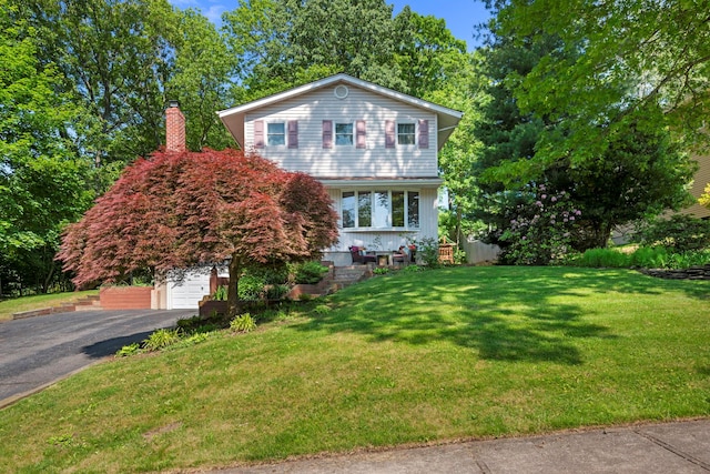 29 Ravenwood Dr, Kings Park, NY 11754 - view of front of property with asphalt driveway, a front yard, and a garage