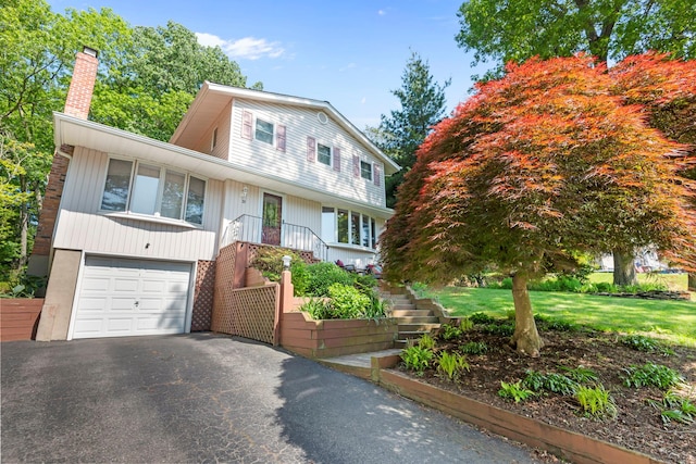 29 Ravenwood Dr, Kings Park, NY 11754 - view of front of property with a chimney, an attached garage, driveway, and stairs