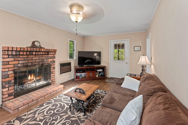 29 Ravenwood Dr, Kings Park, NY 11754 - living room with wood finished floors, plenty of natural light, heating unit, and a fireplace