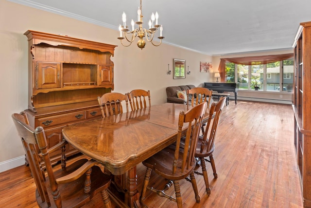 29 Ravenwood Dr, Kings Park, NY 11754 - dining room featuring a chandelier, ornamental molding, light wood-type flooring, a baseboard heating unit, and baseboards