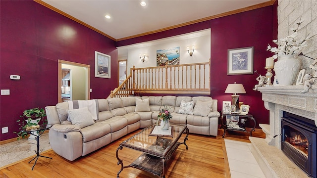 81 Avondale Rd, Yonkers, NY 10710 - living room featuring a large fireplace, wood finished floors, ornamental molding, recessed lighting, and stairs