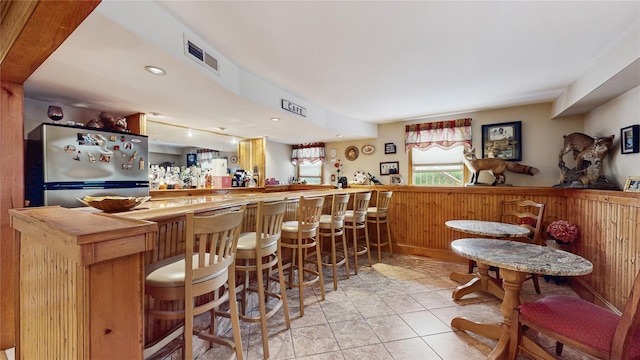 81 Avondale Rd, Yonkers, NY 10710 - indoor dry bar featuring freestanding refrigerator, a wainscoted wall, wood walls, and recessed lighting