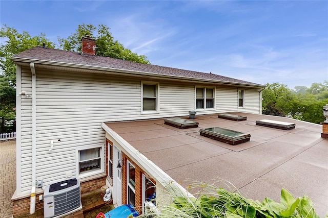 81 Avondale Rd, Yonkers, NY 10710 - rear view of house with a chimney and a patio area