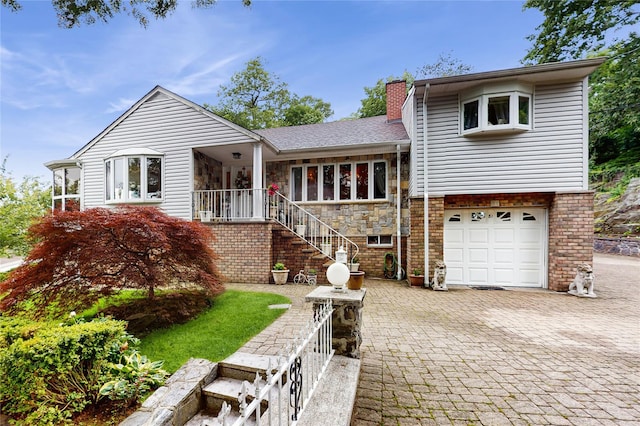 81 Avondale Rd, Yonkers, NY 10710 - view of front of home with decorative driveway, a chimney, an attached garage, stone siding, and a shingled roof