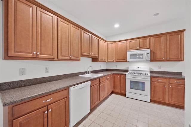 28 Winhaven Ct Unit 20, Highland Falls, NY 10928 - kitchen featuring white appliances, dark countertops, light tile patterned floors, brown cabinetry, and recessed lighting