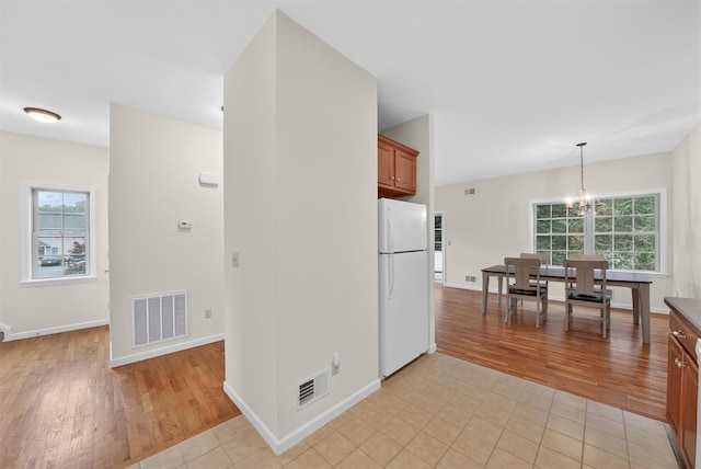 28 Winhaven Ct Unit 20, Highland Falls, NY 10928 - kitchen with freestanding refrigerator, light wood-style flooring, brown cabinets, and hanging light fixtures