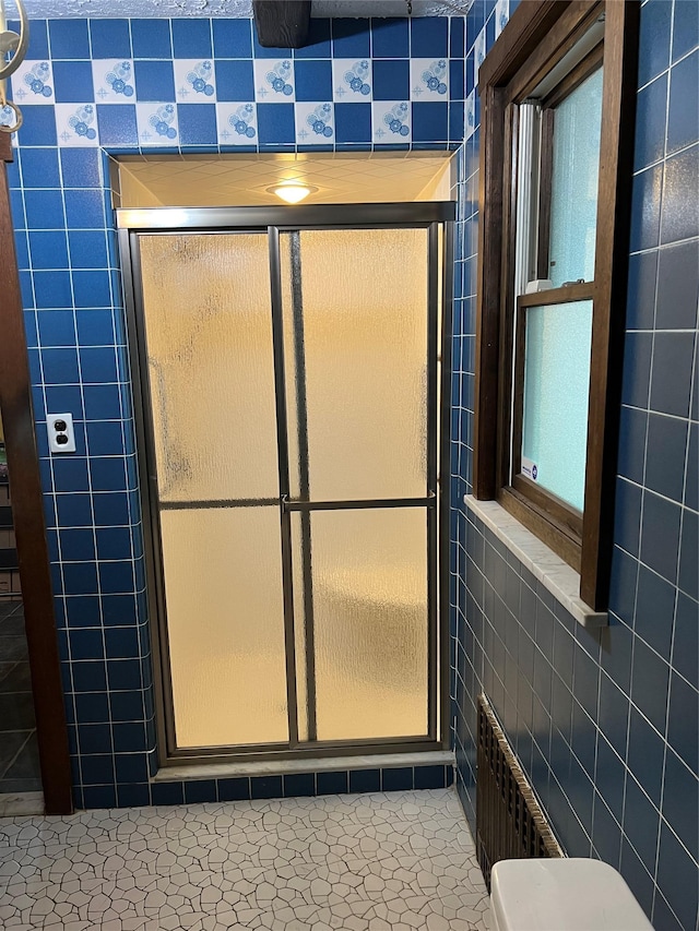 8 Alexine Ave, East Rockaway, NY 11518 - full bathroom featuring a shower stall, tile walls, and toilet