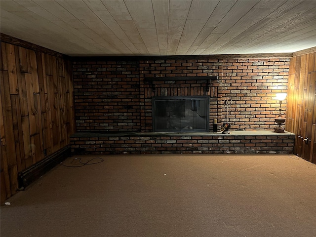 8 Alexine Ave, East Rockaway, NY 11518 - unfurnished living room with carpet, wood walls, wooden ceiling, a fireplace, and brick wall