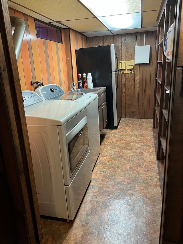 8 Alexine Ave, East Rockaway, NY 11518 - laundry area featuring washing machine and dryer, cabinet space, wooden walls, and light stone finish flooring
